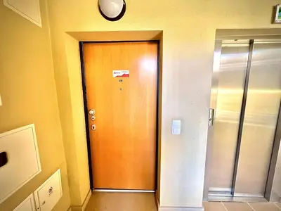 a wooden door in a hallway with a clock at Vilamoura Prestige 2 With Pool by Homing in Vilamoura