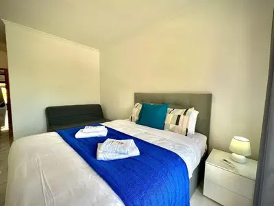 a bedroom with a bed with two towels on it at Vilamoura Prestige 2 With Pool by Homing in Vilamoura