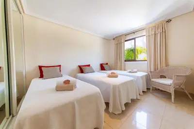 a room with two beds and a window at Apartment Santa Monica by Algarve Vacation in Albufeira