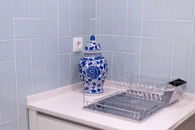 a blue and white vase sitting on a shelf at Villa Golden Falésia by HelloVacations in Albufeira