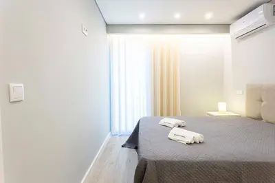 a bedroom with a bed with two towels on it at Villa Serenity Falésia by HelloVacations in Albufeira