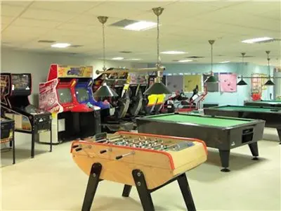 a room with a pool table and other games at Perfect Albufeira 1 Bedroom apartment in Albufeira