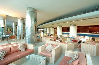 a lobby with couches and people sitting at tables at Perfect Albufeira 1 Bedroom apartment in Albufeira