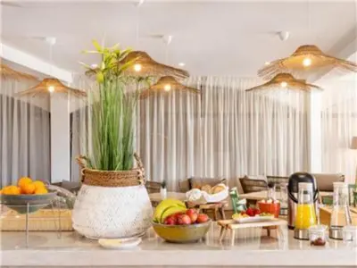 a living room with a vase with fruit on a counter at Perfect ApartHotel 1 Bedroom in Olhos de Água