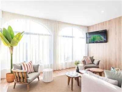 a living room with two couches and a tv at Perfect ApartHotel 1 Bedroom in Olhos de Água