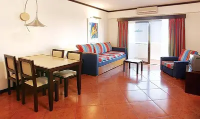 a living room with a couch and a table at Exciting Albufeira Studio in Albufeira