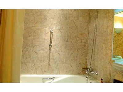 a shower in a bathroom with a tub and a sink at Exciting Albufeira Studio in Albufeira