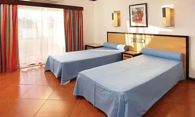 a hotel room with two beds and a window at Spectacular Albufeira 2 Bedroom apartment in the city center in Albufeira