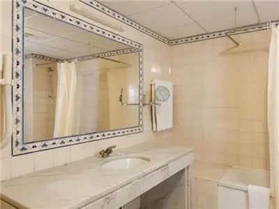 a bathroom with a sink and a mirror and a tub at Fantastic Apartments 1 Bedroom in Olhos de Água