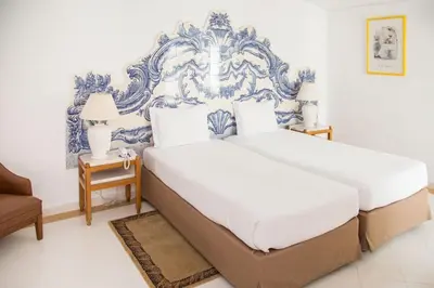 two beds in a bedroom with blue and white at Brilliant Apartments 1 Beedroom in Quarteira