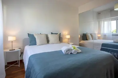 a bedroom with a large bed with towels on it at Sun & salt Apartment in Albufeira