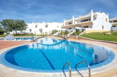 a large swimming pool in front of a building at Summer Villa in Albufeira