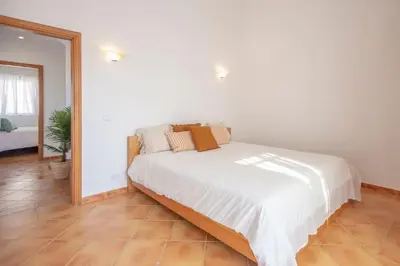 a white bed in a room with a mirror at Summer Villa in Albufeira