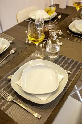 a table with a white plate and glasses of wine at Apartment Sandi in Albufeira