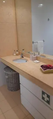 a bathroom counter with a sink and a mirror at Recanto de Férias in Albufeira
