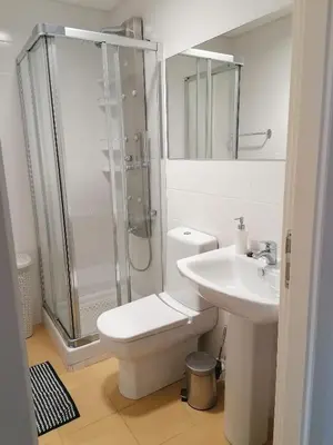 a bathroom with a shower and a toilet and a sink at Recanto de Férias in Albufeira