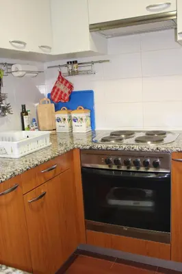 a kitchen with a stove and a counter top at Recanto de Férias in Albufeira