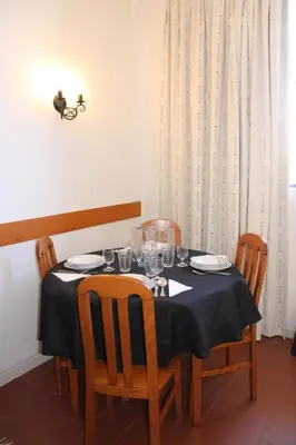 a dining room table with a blue table cloth and chairs at Recanto de Férias in Albufeira