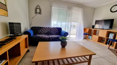 a living room with a couch and a table at Casa ARRIFES in Albufeira