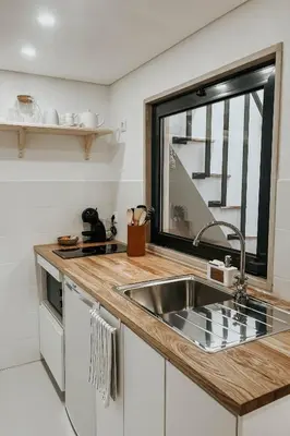 a kitchen with a sink and a window at Casa Melro in Faro
