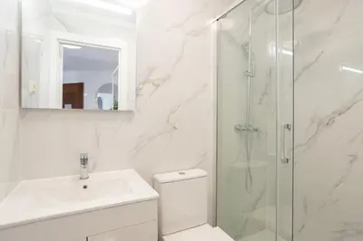 a bathroom with a shower and a toilet and a sink at TAC - Bliss Vilamoura in Quarteira