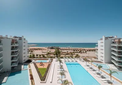 an aerial view of the pool and the beach at Dom Pedro Residences in Vilamoura