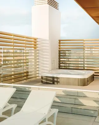 a spa room with a large bed and benches at Dom Pedro Residences in Vilamoura
