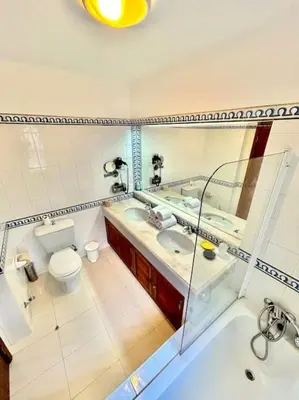 a bathroom with a sink and a toilet and a tub at Heart of Quinta do Lago ! in Faro