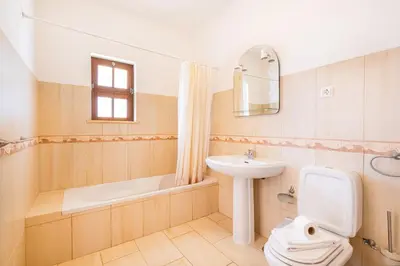 a bathroom with a sink and a toilet and a bath tub at Villa Brid in Albufeira