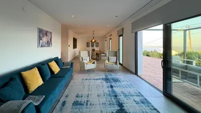 a living room with a blue couch and chairs at Casa da Cotovia, Loule in Loulé