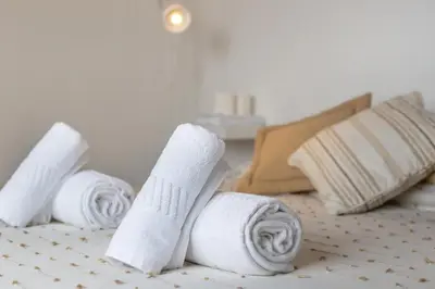 a group of rolled towels on a bed at Blife RYA private rooms - Airport stay in Faro