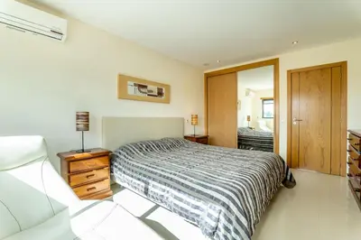 a bedroom with a bed and a mirror at Villa Feliz Algarve with Private Pool - São Rafael in Albufeira