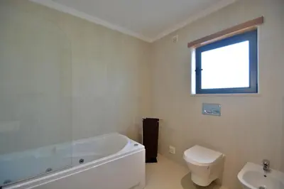 a bathroom with a tub and a toilet and a sink at Villa Feliz Algarve with Private Pool - São Rafael in Albufeira