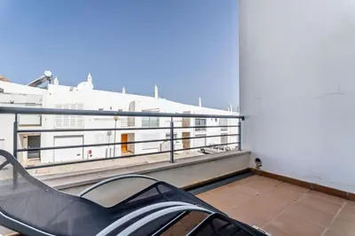 a bench on the balcony of a building at Villa Feliz Algarve with Private Pool - São Rafael in Albufeira