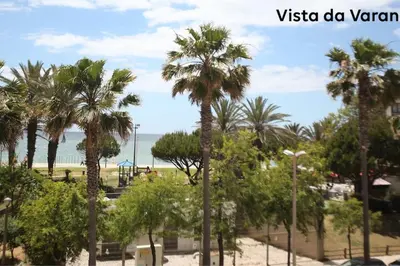 a group of palm trees on the beach at Atlantic Pearl by the Sea - Quarteira in Quarteira
