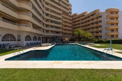 a swimming pool in front of a building at MILA - Vilamoura in Vilamoura