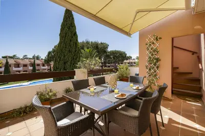 a patio with a table and chairs on a balcony at BmyGuest - Vilamoura Vila Sol Golf II in Vilamoura