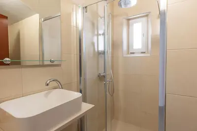 a bathroom with a sink and a shower at Villa Eskape in Albufeira
