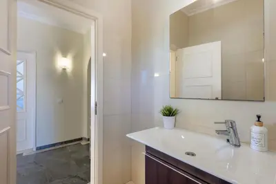 a bathroom with a sink and a mirror at Villa Pinheiro in Albufeira