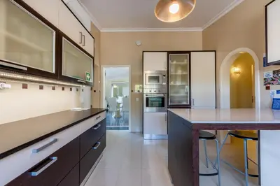 a room with a balcony with a table and chairs at Villa Pinheiro in Albufeira