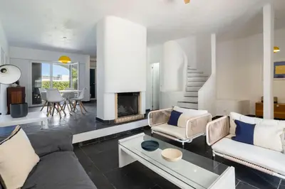 a living room with a couch and a fireplace at Centralgarve - Excellent & Peaceful Villa in the Center of Vilamoura in Vilamoura