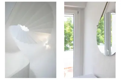 a white house with a staircase and a mirror at Centralgarve - Excellent & Peaceful Villa in the Center of Vilamoura in Vilamoura