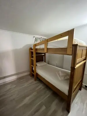 two bunk beds in a room with wooden floors at Rui's Studio - Farmvillage - Free Wifi in Albufeira