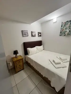 a small bedroom with a bed and a night stand at Rui's Studio - Farmvillage - Free Wifi in Albufeira