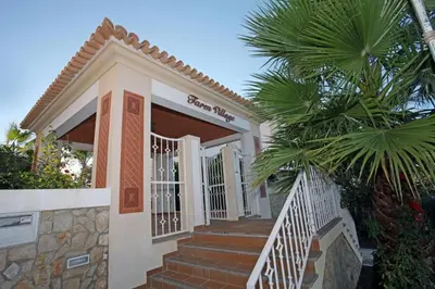 a small house with stairs and a palm tree at Rui's Studio - Farmvillage - Free Wifi in Albufeira
