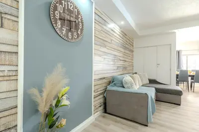 a wooden table and chairs in a room with a bed at #212 Vila Magna 106B by Home Holidays in Albufeira