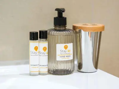 three bottles of soap sitting next to a container at White 47 House by Stay ici Algarve Holiday Rental in Albufeira