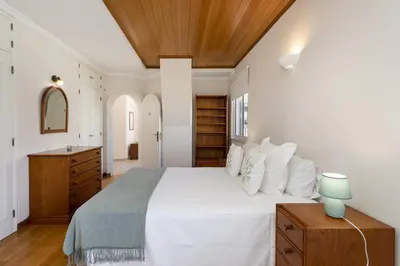 a bedroom with a white bed and a wooden ceiling at Vila Caraibas - Vilamoura - by HDproperties in Vilamoura