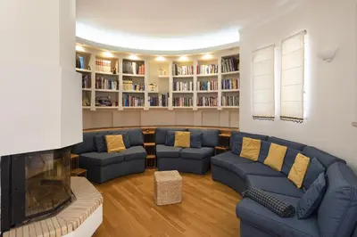 a living room with blue couches and a fireplace at Vila Caraibas - Vilamoura - by HDproperties in Vilamoura