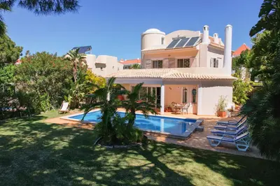 a house with a swimming pool in front of it at Vila Caraibas - Vilamoura - by HDproperties in Vilamoura